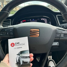 Close up of car wheel with CAN PHANTOM leaflet held up