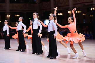 Children dance in ballroom