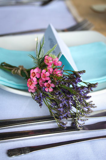 Floral wedding favour, pictured on a wedding reception table setting.