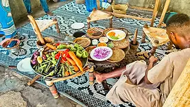 Cours de cuisine dans une ferme aux épices vers Dole à Zanzibar avec produits frais, gestes locaux et atmosphère swahilie.