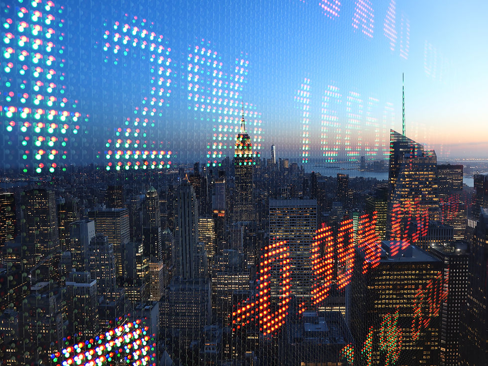 Dusk view of the New York City skyline seen through colorful LED reflections on glass, with the Empire State Building centered.