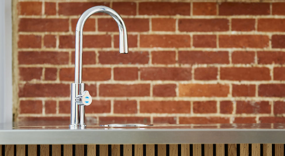 A Zip tap in a home media room with exposed brick wall