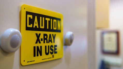 "Caution X-Ray In Use" sign as introduction to long term disability for radiologists
