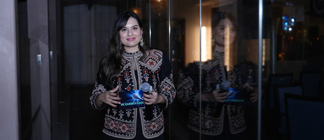 MC Karnica Karda hosting a Diwali event in Dubai in an Indo-western outfit