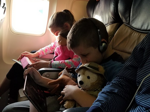Sitting in airplane seats with kids