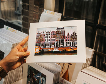 Postcard showing typical Amsterdam houses lined up along the canals