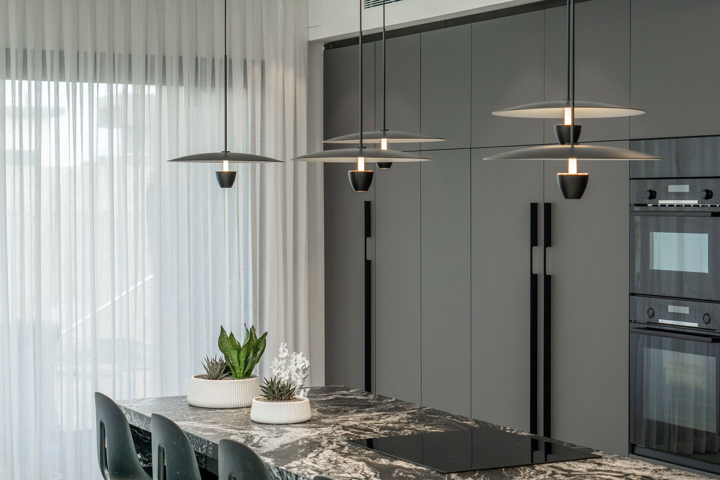 מבט אל המנורות התלויות מעל האי במטבח