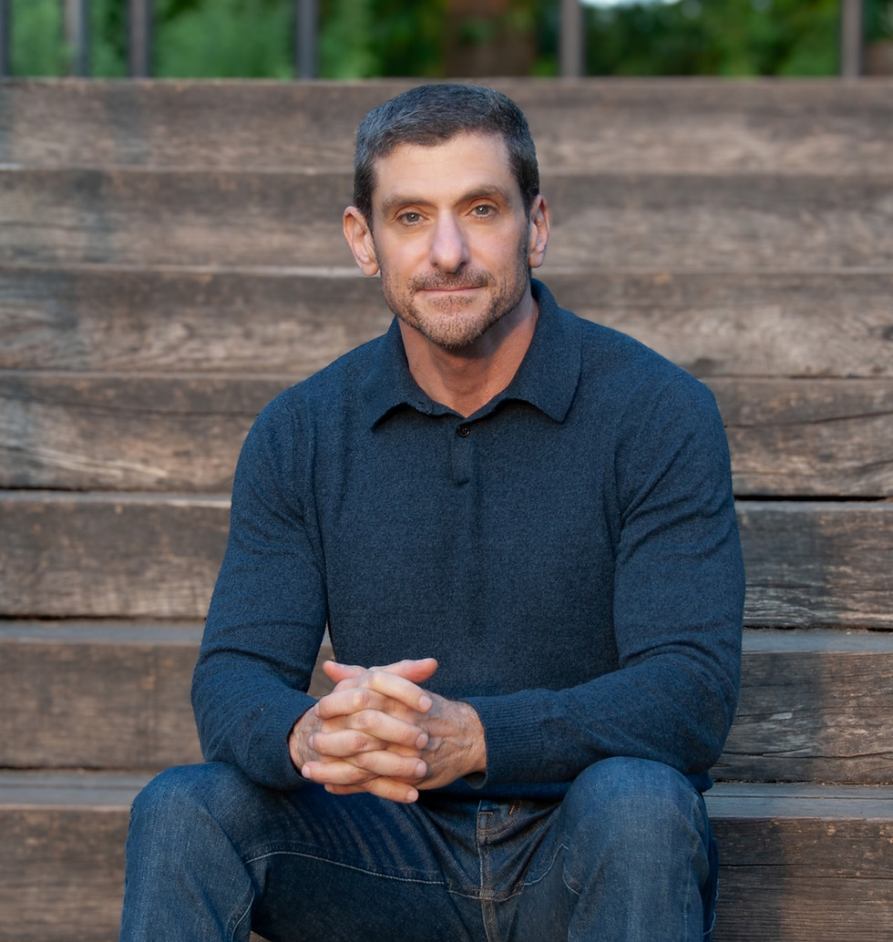 Dr. Amir Levine sitting on a staircase