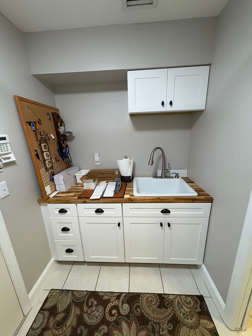 Close-up view of a butcher block countertop on a custom laundry cabinet