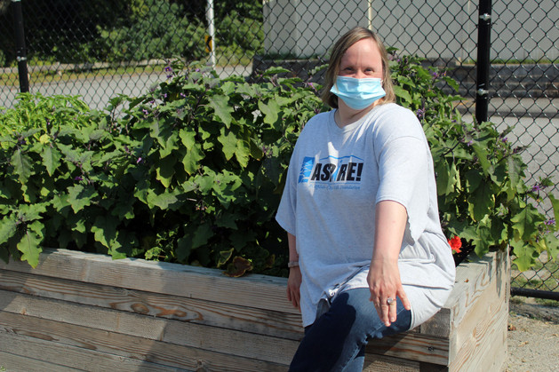 Woman standing by a garden
