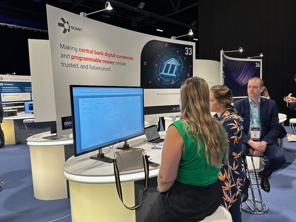 Senior Product Manager and Chief Product Officer engaged in conversation at the exhibition stand.