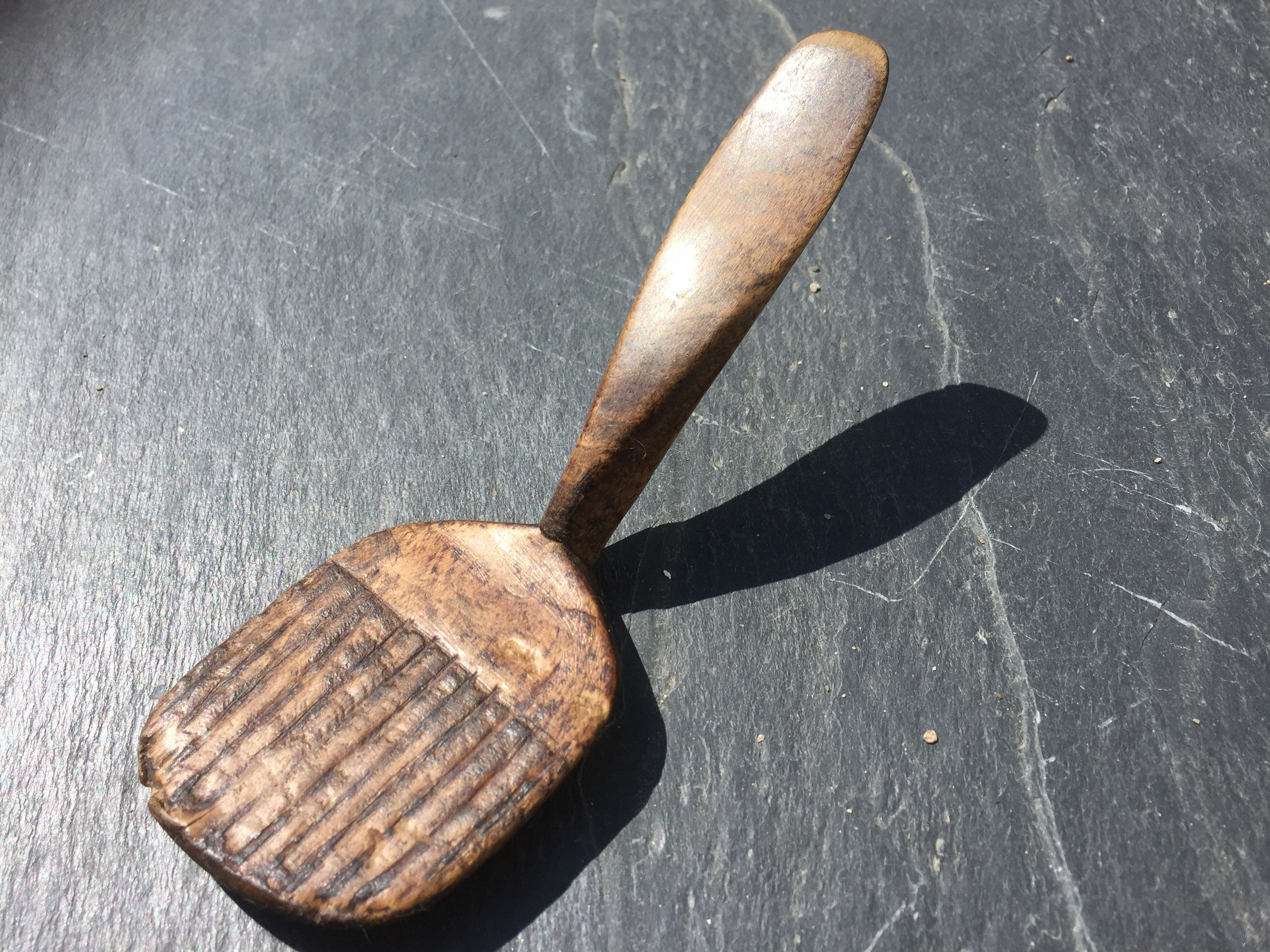 An Antique Treen Butter Spoon