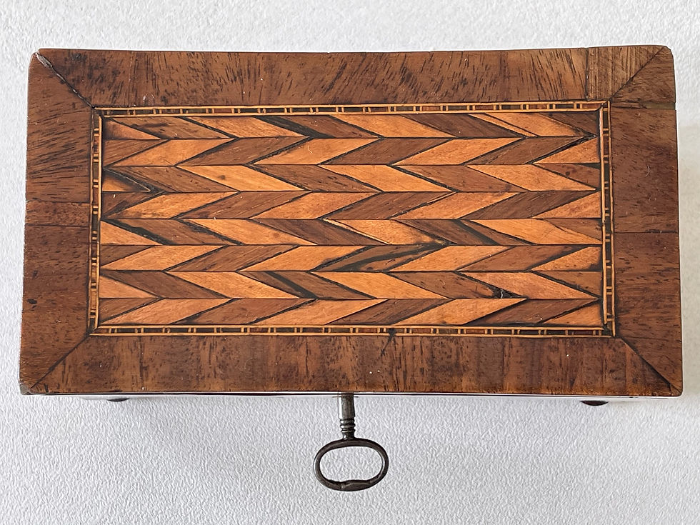 A Georgian Flame Mahogany Tea Caddy - with inlaid lid