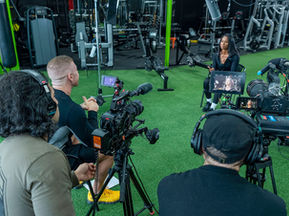 Filming a corporate video, capturing energy, movement, and brand storytelling in an active environment.