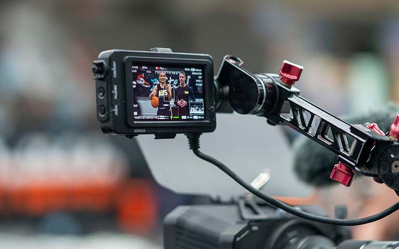 BTS of filming a training video in a basketball court.