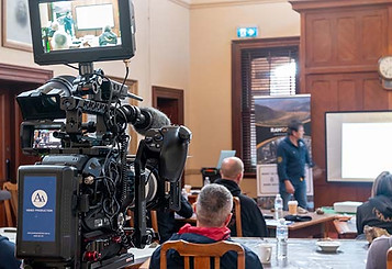 Camera filming a presenter during a workplace training session