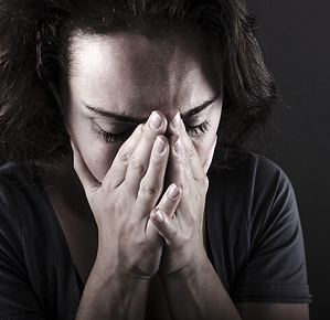 Person looking upset with head down in hands needing counseling in Englewood, CO for PTSD treatment and trauma therapy. You can get help and trauma counseling in the Denver area at Catalyss Counseling 80209 and 80210