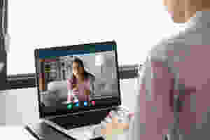 Person is sitting at desk while takes part in telehealth session at Catalyss Counseling in Colorado. Our caring therapists provide you with solutions to your treatment needs doing online therapy and online counseling in the Denver CO area 80209 and 80210
