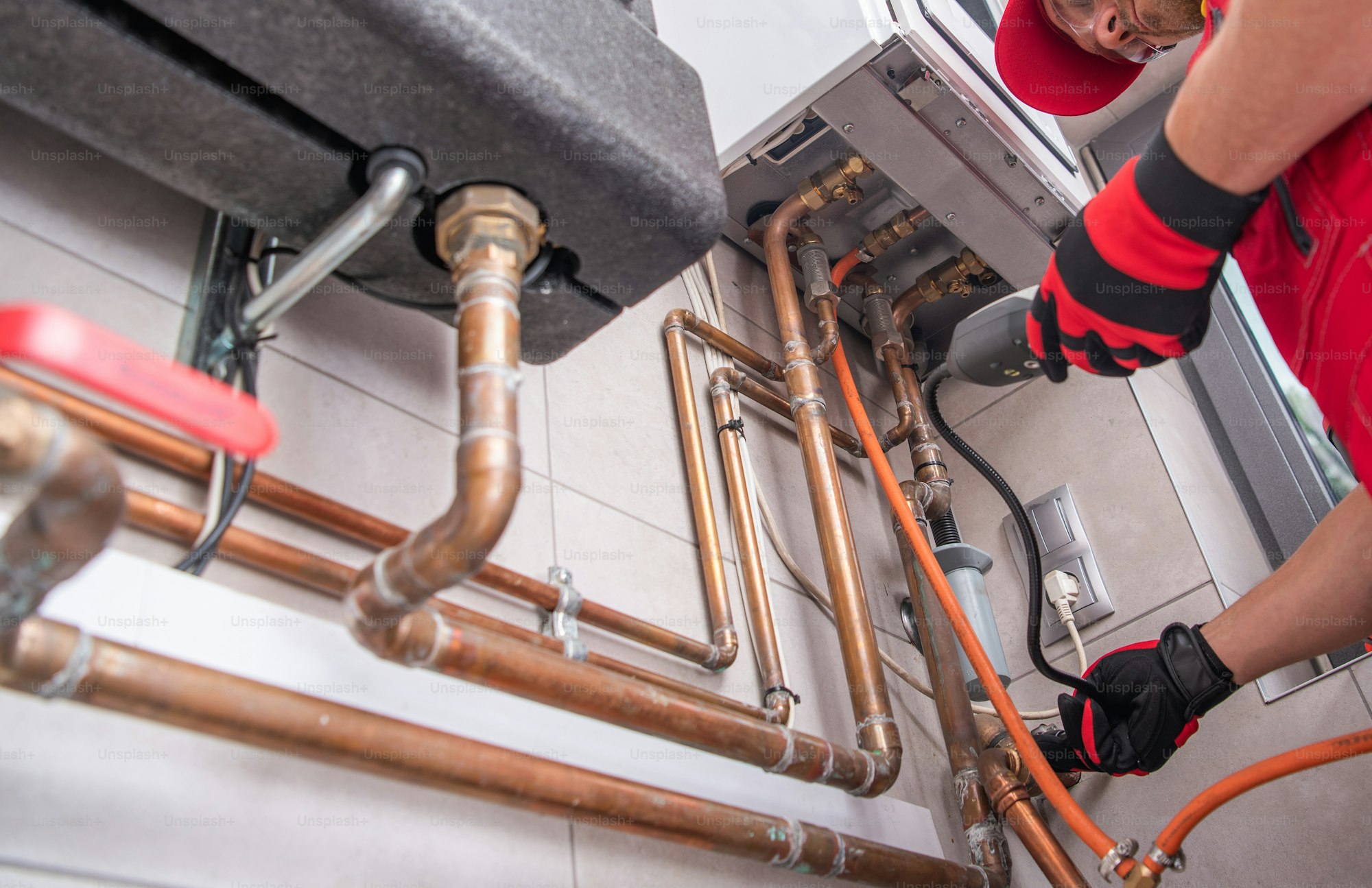 GO Mechanical heating specialist performing a gas-leak check