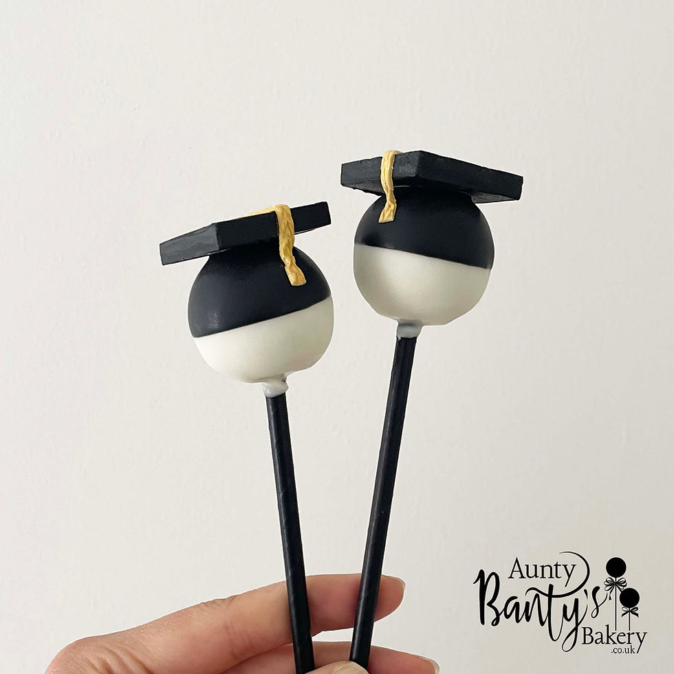 Thumbnail: Graduation cake pops held in hand showing size and detail.