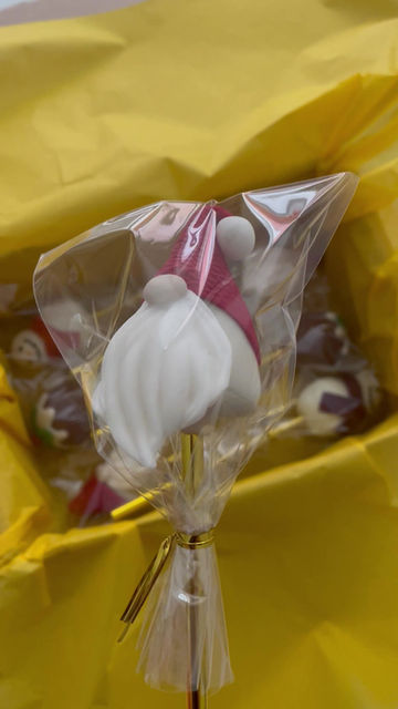Thumbnail: Handcrafted Santa cake pop in clear cellophane bag, with floppy red hat, white beard, and round nose