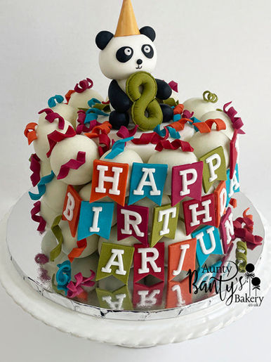 Colourful Panda themed cake pop celebration cake, decorated in a fondant panda topper and decorated in a colourful fondant birthday banner and streamers. Available for collection from Wolverhampton.