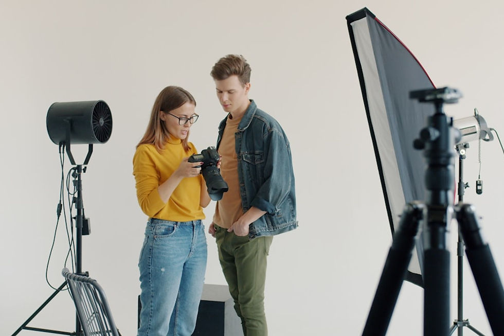 Two people looking at a camera in a studio.