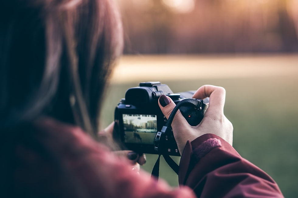 woman holding black DSLR camera