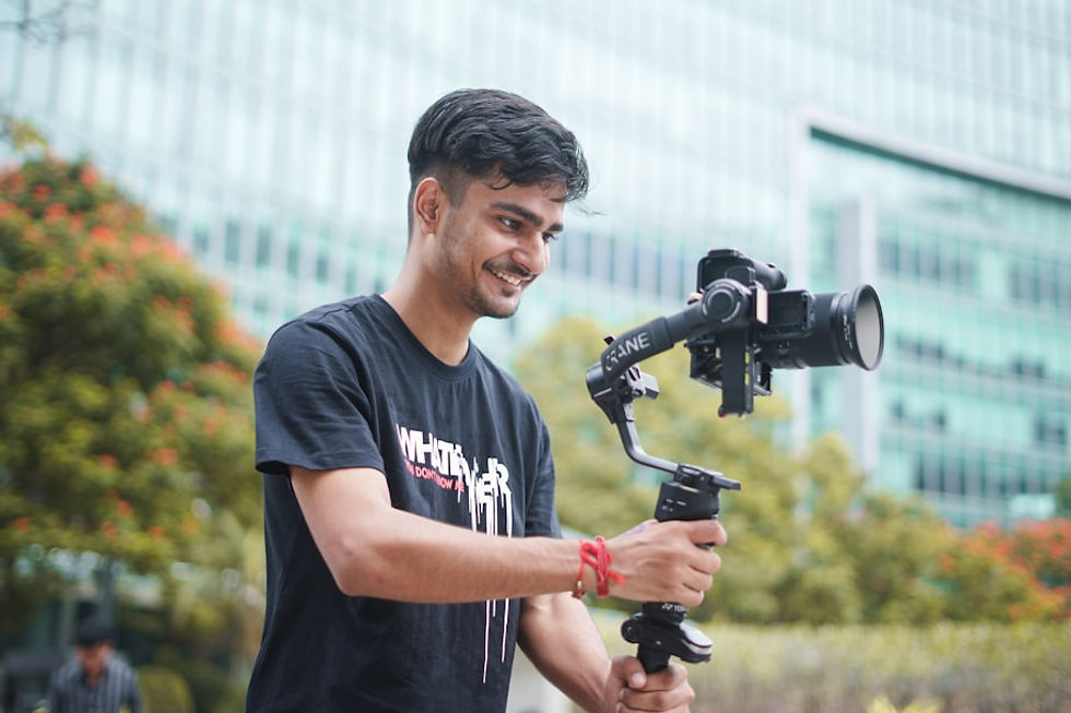 Young man smiling while operating a camera gimbal