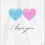 Thumbnail: Wedding Card Front - "I love you" featuring two interlocking fingerprint hearts, one blue and one pink