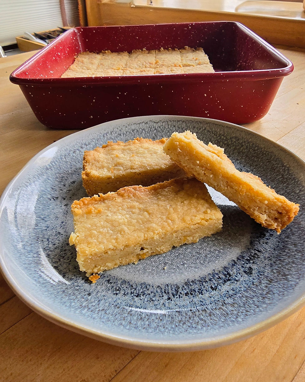 Three cardamom shortbread cookies sitting on a small blue plate.