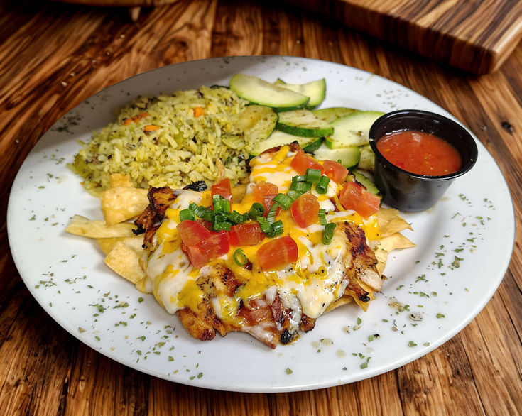 Grilled margarita marinade chicken breast topped with melted cheddar and monterey jack cheese, then sprinkled with diced tomatoes, chives and tortilla strips. Served with seasonal vegetables and wild rice. Side of homemade salsa.