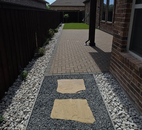 Paver patio overlay with turf and rocks in Arlington, Tx.