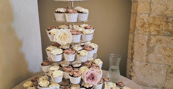 A stunning 6 tier cupcake tower with a beautiful topper cake
