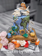 Cake decorated with a world map and airplane.