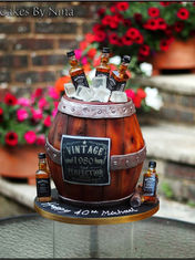 Barrel-shaped 3d cake with whiskey bottles on Celebration site.