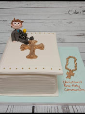 Christening cake with a boy figurine and cross