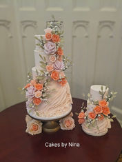 Gorgeous soft peach background with sugar swags and lots of sugar flowers and foliage wedding cake delivered to The Elvetham