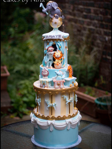 Stunning blue and gold circus cake with an lovely handmade elephant on the top