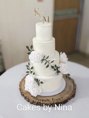 Four-tier buttercream cake with floral accents from Cakes by Nina