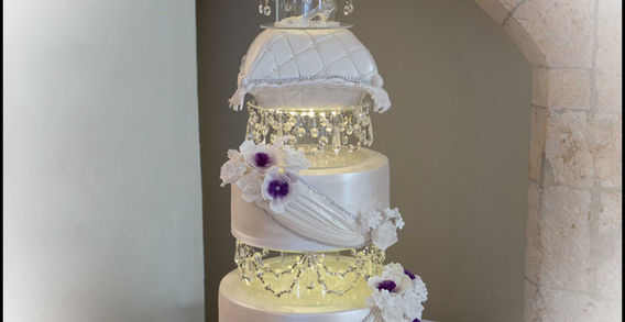 A showstopper of a cake with light up crystal tiers and cushion shaped cakes