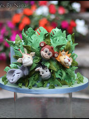 lots of cheeky faces peaking out of this 8" jungle inspired cak