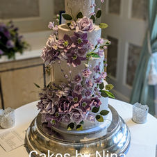 Stunning sugar flower and lace details wedding cake with various hints of lilac and violet