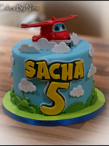Simply cute blue background sky cake with a cute aeroplane on the top