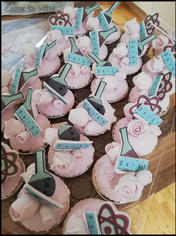 Science-themed pink cupcakes with atom and beaker toppers.
