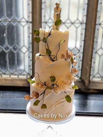 Elegant ivory wedding cake with torn wafer paper detailing, handcrafted sugar flowers, marble effect and delicate sugar foliage by Cakes by Nina.foliage, truly elegant wedding cake - Horsley Towers
