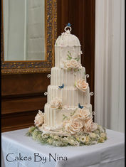 Love Bird Birdcage luxury four tier ivory wedding cake with ornate birdcage sugar structure, handmade sugar roses, lace detailing and blue sugar butterflies at Barnett Hill
