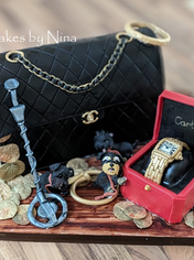 Cake in the shape of a purse, watch and other ornaments from Celebration site.