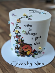 Cake decorated with flowers and an owl