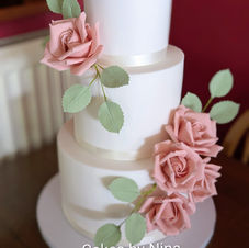 Stunning sugar flower and lace details wedding cake with various hints of dusky pink and sage wedding cake